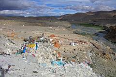 
After the hot springs the trail climbs past a cremation area consecrated to Yeshe Tsogyal, and then reaches a miniature version of Kailash's D�lma La, marked with mani stones, prayer flags and a large collection of yak horns and skulls. To the left is the end of a recently constructed over 200m long mani wall, which points to the northeast directly towards Mount Kailas. The wall was the end result of a demon firing an arrow at the guru. He stopped the arrow's flight and transformed it into this wall.
